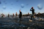 Athletes run into the water as they start the first leg of the Los Angeles Triathlon, in Venice CA, Sunday, September 9, 2007.