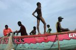 Fishermen pull in a net in Aberdeen near Freetown, Sierra Leone, November 15, 2008.