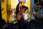 Esaie Jean washes himself in the harbor in Port-au-Prince, Haiti, February 17, 2004.