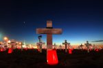 Candles burn among 2050 erected memorial crosses for those who have fallen in Iraq, at the Arlington West Memorial, erected by Veterans for Peace, by Santa Monica Pier in Santa Monica, Nov. 11, 2005. The death toll now totals 2061.
Photo by:Ann Johansson.