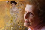 Maria Altmann, niece of Adele and Ferdinand Bloch-Bauer, poses next to a reproduction of a painting of her aunt Adele done by Gustav Klimt, in her home in Los Angeles, Friday, April 8, 2005. The original painting was stolen by Nazis during the second world war. A federal judge recently awarded Altmann and other heirs of two victimized families $21.9 million.