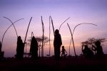 Tuareg women and children build a traditional tent as they expect visitors from a nearby village to attend a wedding, in Kanak village, Niger, February 2005. Niger has been struggling with a severe food shortage caused by drought.