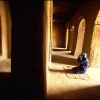 A man kneels in prayer in one of the great mosques of Timbuktu. The town remains the repository of thousands of ancient manuscripts dating to a time when the city rivaled Damascus, Baghdad, and Cairo as one of the great centres of Islamic culture and learning. One can cradle in one’s hand a document embossed in gold and copied in the thirteenth century from an Avicenna manuscript written in the year 1037.