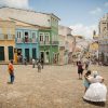 Visitors enjoy the colonial quarter of Bahía, or Salvador, the heart of Afro-Brazilian culture. Travel is a 3.5-trillion-dollar business, the largest economic engine in the global economy. Tourists fly to the most remote outposts of the planet in a day with absolute assurance that they will be able to scurry back home in a week, just in time for a family wedding. By contrast the traveller is loyal to everywhere and nowhere, with home being the ground beneath one’s feet and movement the natural way of things. The quality of a journey, not the remoteness of its destination, lends meaning to travel, and it is time alone that allows a traveller to be transformed, which ultimately is the goal of every journey.