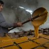 A farmer in Huila, Colombia, close to the headwaters of the Río Magdalena, prepares panela, blocks of raw sugar processed from cane juice and boiled down to a thick concentrate that is poured into molds to harden.